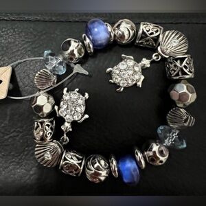 NWT Odri women’s silver tone charm stretch bracelet